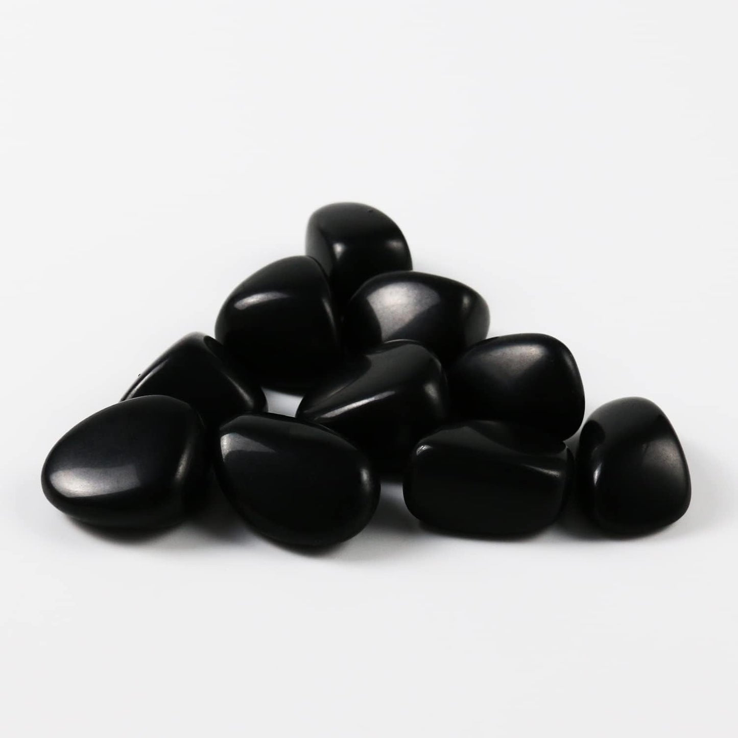 High-polish black obsidian tumbled stones for Feng Shui protection and root chakra grounding