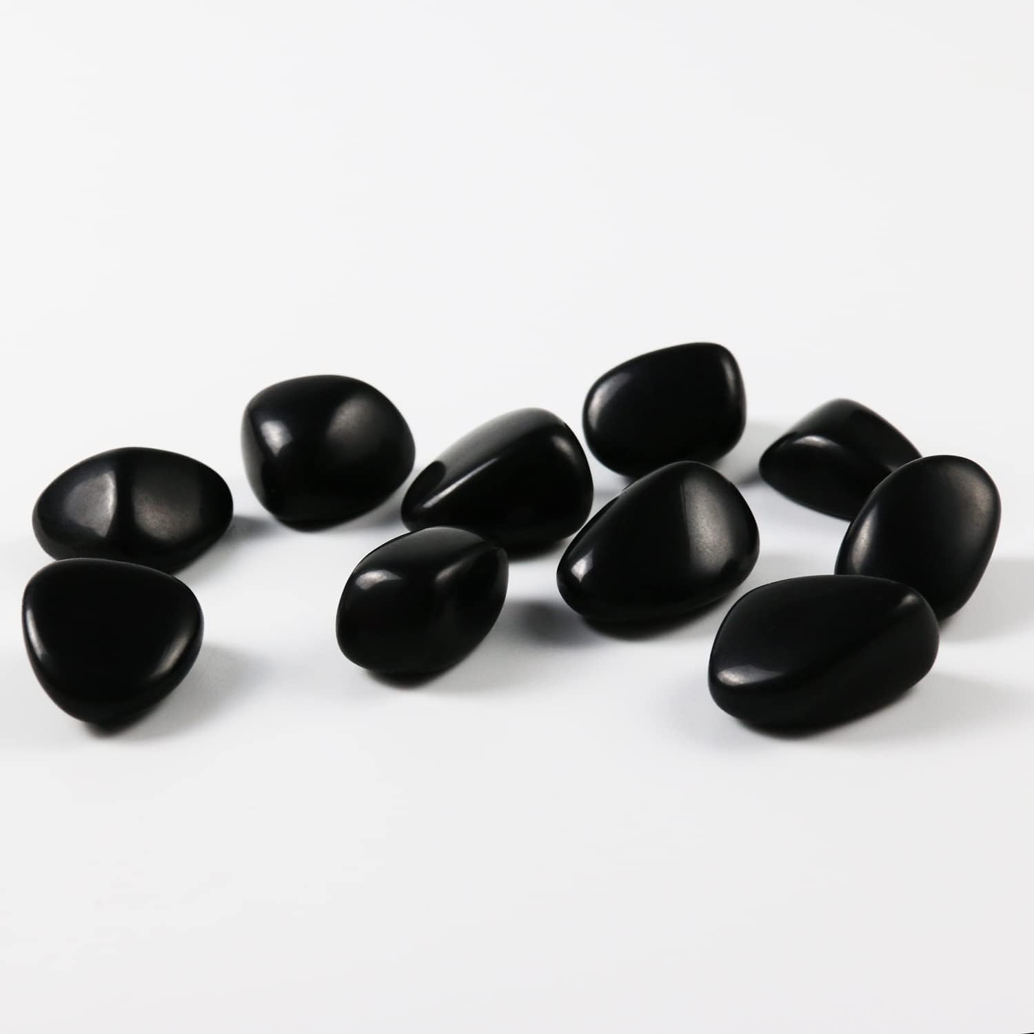 High-polish black obsidian tumbled stones for Feng Shui protection and root chakra grounding