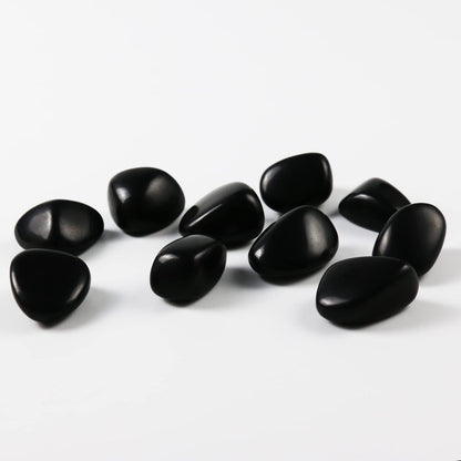 High-polish black obsidian tumbled stones for Feng Shui protection and root chakra grounding