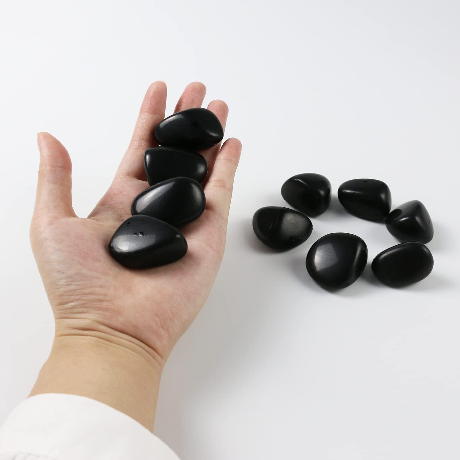 High-polish black obsidian tumbled stones for Feng Shui protection and root chakra grounding
